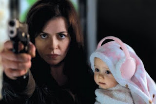 Gwen Cooper (Eve Myles) protects her baby daughter Anwen from the forces of darkness in Torchwood: Miracle Day